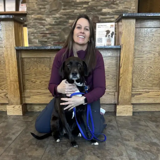 Pam holding dog in the North Iredell Animal Hospital reception area.